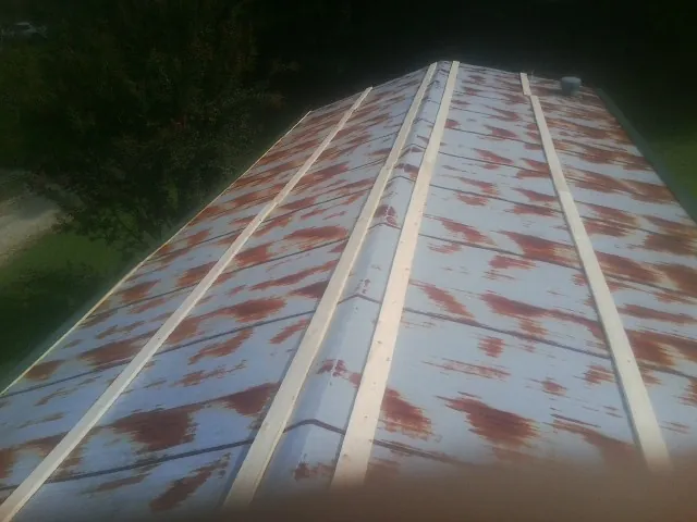 Rusted metal roof panels with new wood purlins before replacement — Storm Damage Roof Repair in Brunson by Roofing Brothers